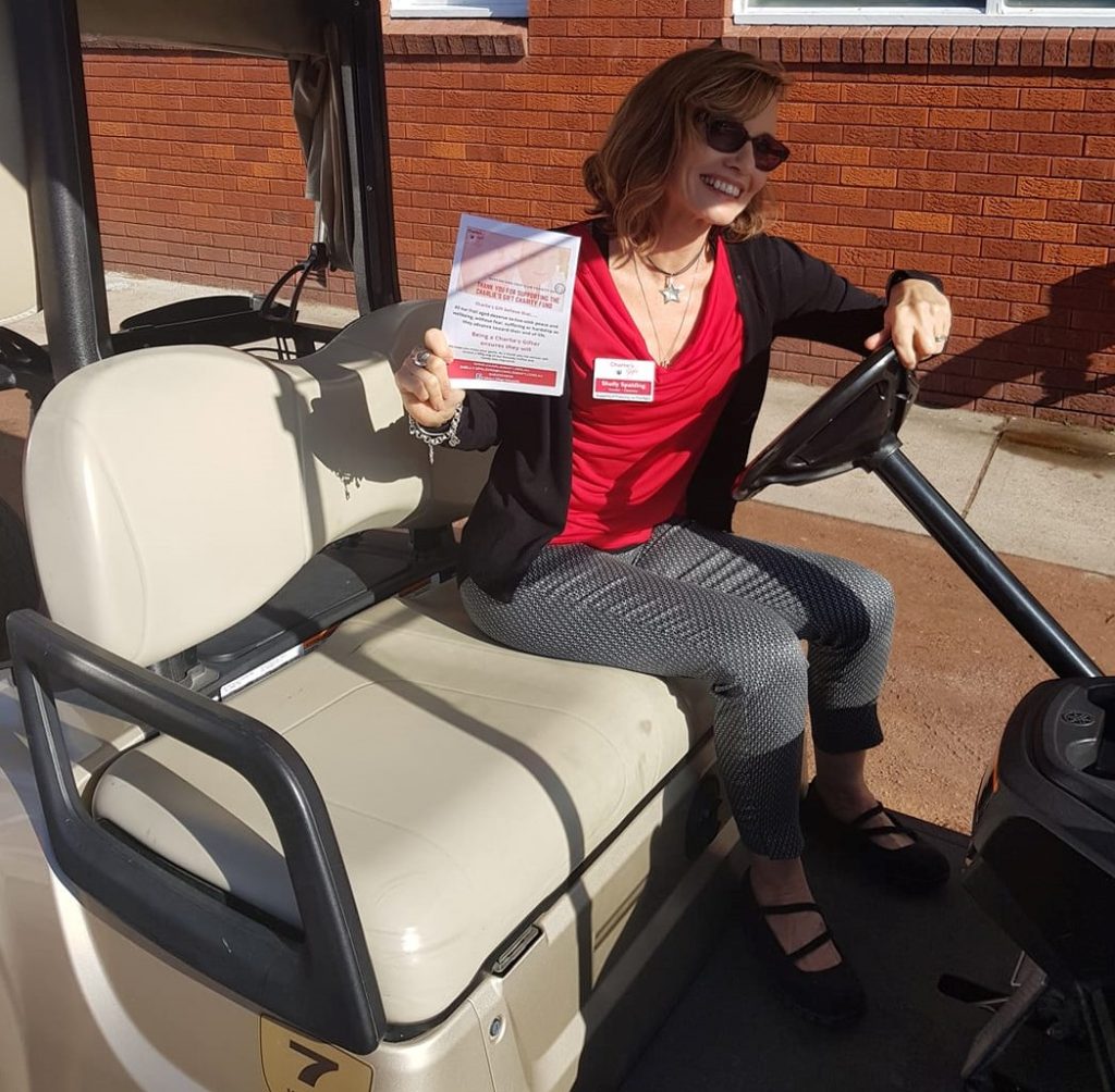 Shelly driving golf cart at the charity golf day