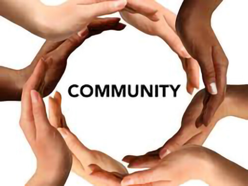 hands forming a circle around the word community